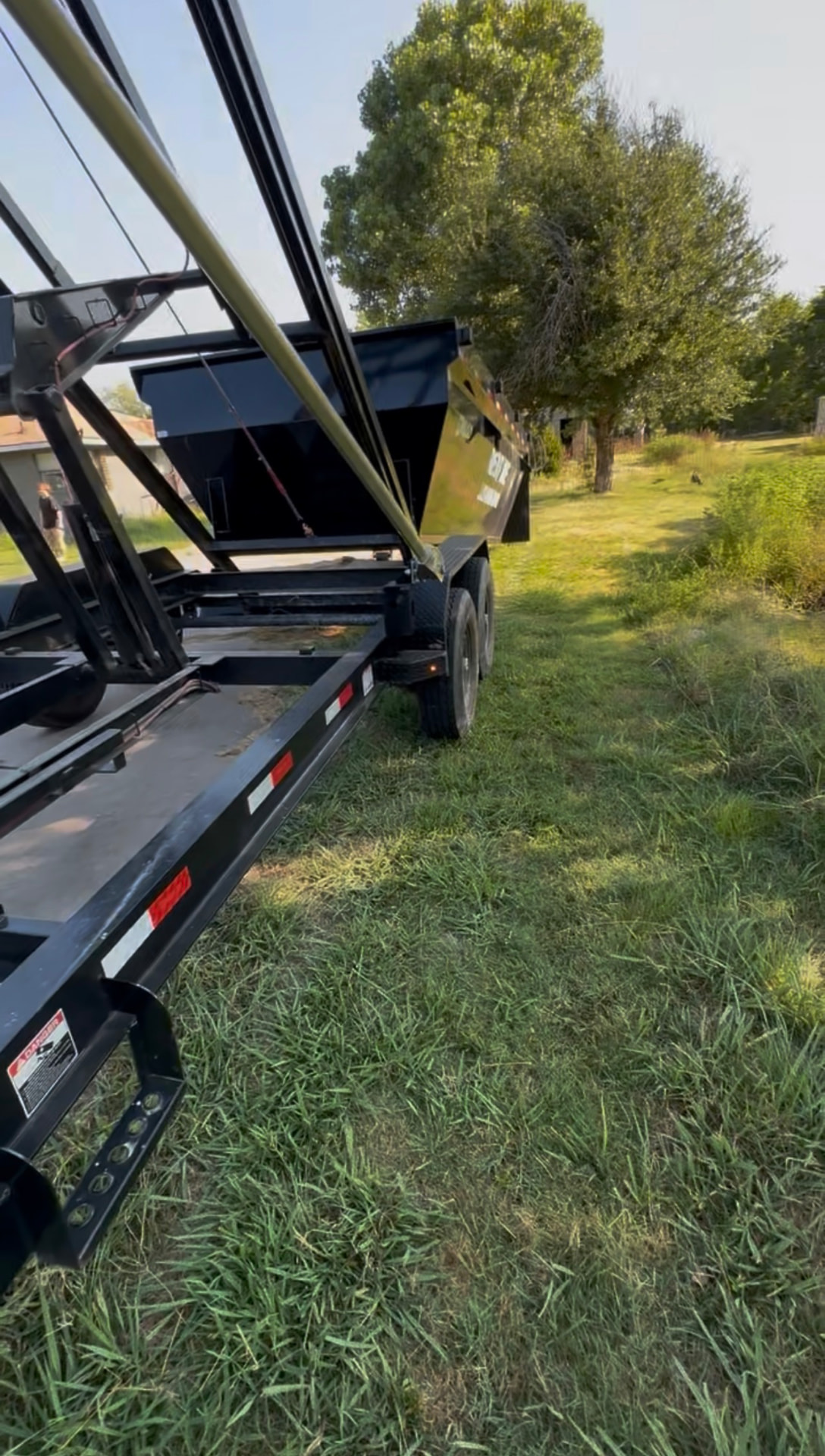 16-yard dumpster delivery placed on a grass yard in Greenville, TX by HomeHaven Dumpsters