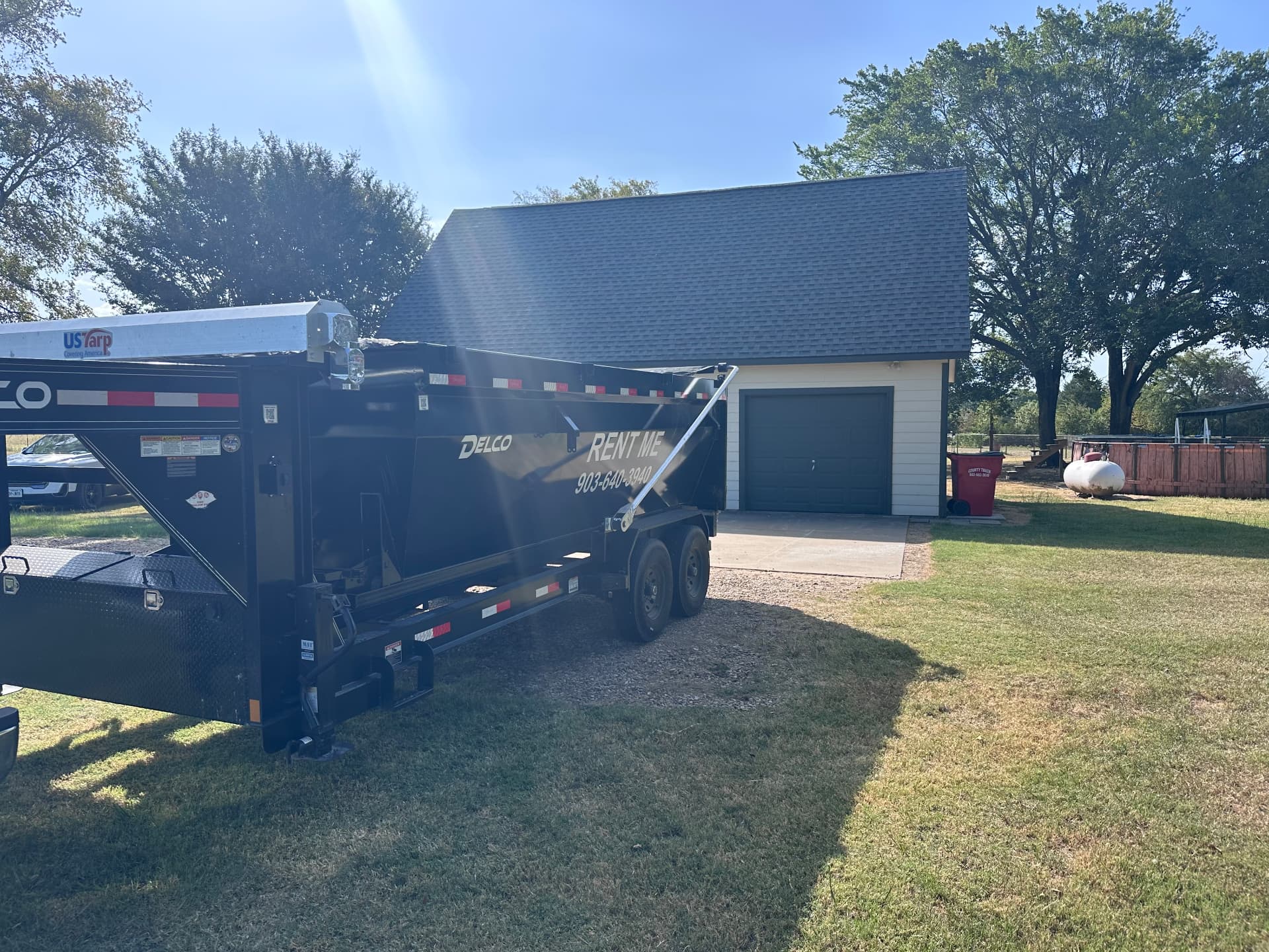 HomeHaven setting a 16-yard roll-off dumpster down beside a North Texas garage driveway